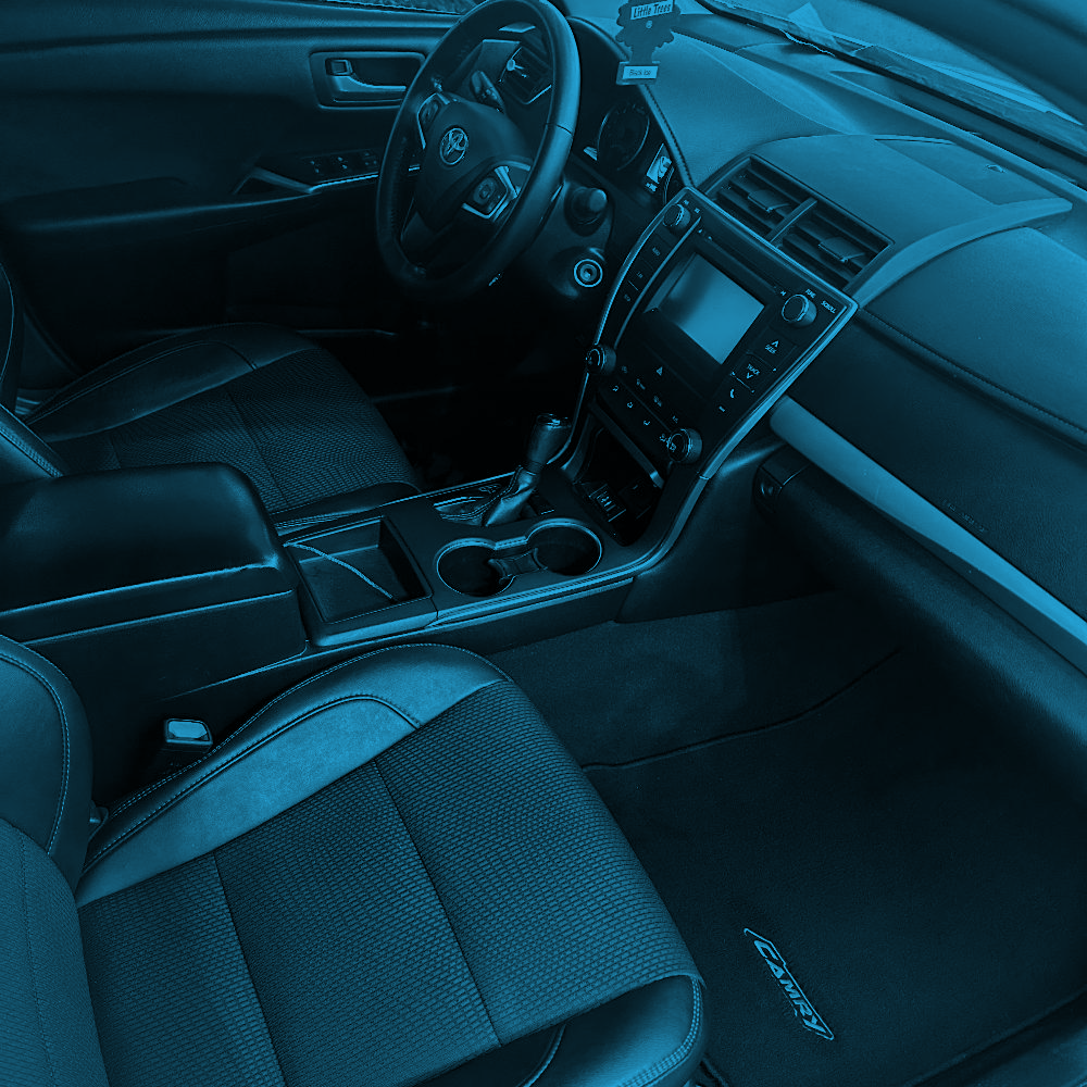 Interior of a car cleaned and detailed as part of the Interior Package, highlighting clean seats, floor mats and dashboard.